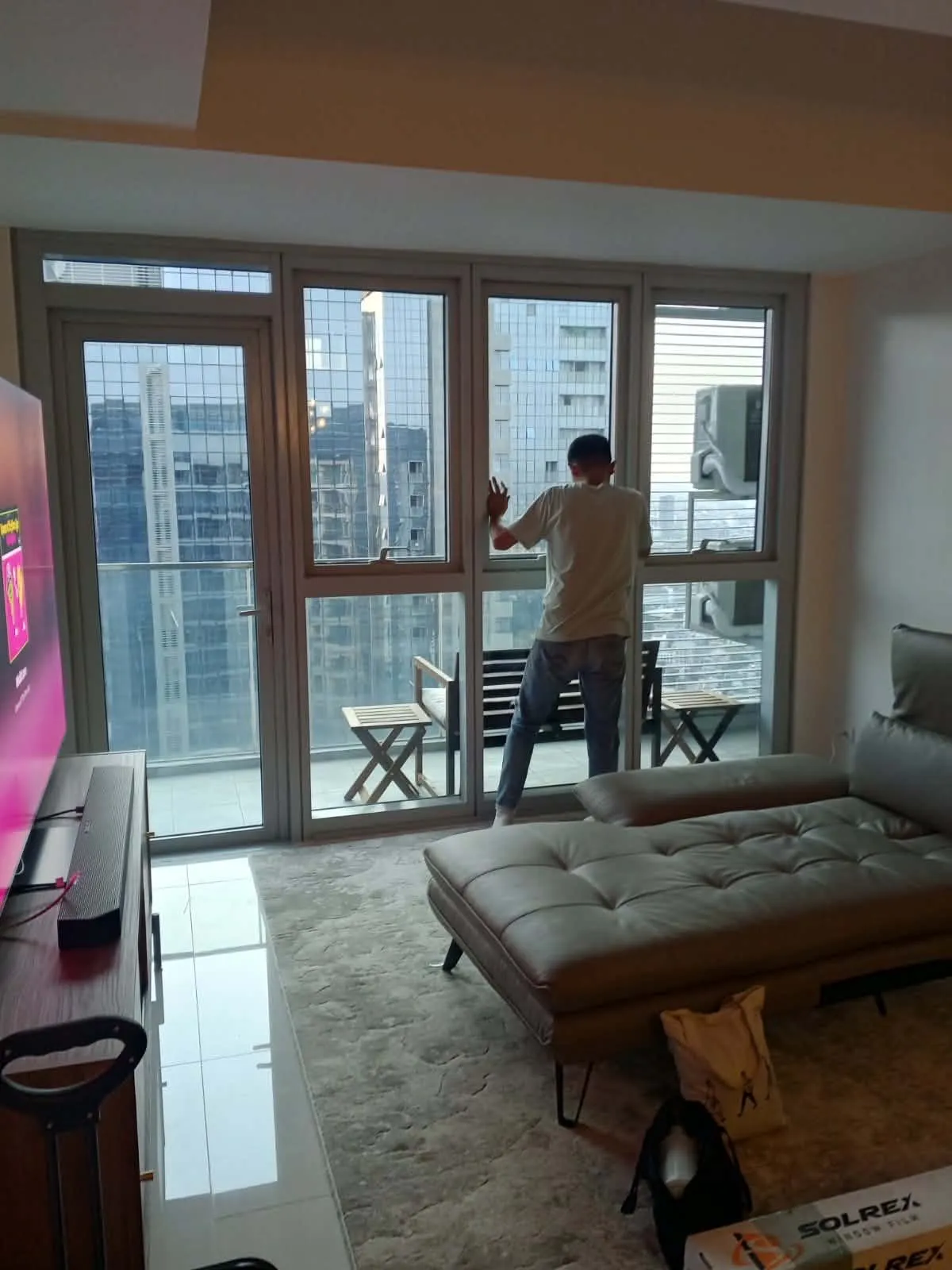 Tint Pro professional installation team executing window film layout inside an apartment condominium